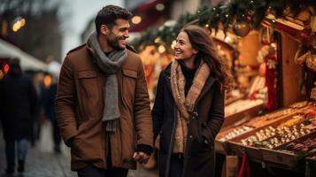 Couple enjoying Christmas market walking near stalls photo