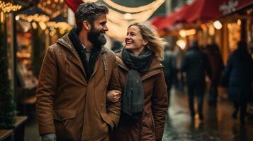 Couple enjoying Christmas market walking near stalls photo