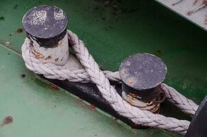 a close up of two metal rods on a green boat photo