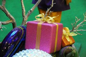 a purple gift box with a bow and some other items photo