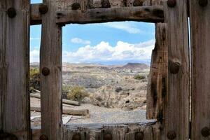 a view through a window of a wooden fence photo