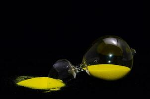 A hourglass with yellow sand photo