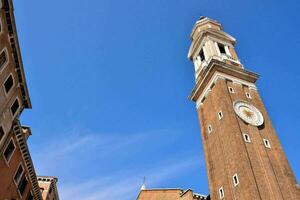 a tall clock tower in the middle of a city photo