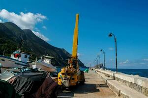 a crane is parked on the side of a pier photo