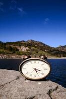 A clock on a rock photo