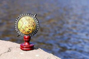 An earth globe on a rock photo