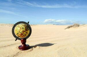 A globe in the sand photo