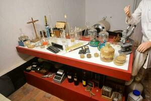 a man standing in front of a table with various items photo