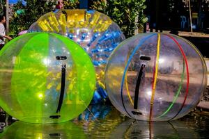three inflatable balls are sitting in a pond photo