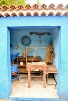 a blue house with a wooden bench photo