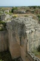 the ruins of a large stone structure near the ocean photo