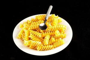 A pasta plate on black background photo