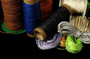 Spools of thread on black background photo