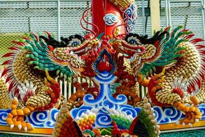 a dragon boat is decorated with colorful dragon heads photo