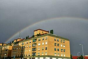 a rainbow appears over a building photo