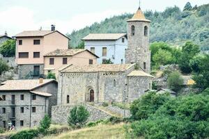 a church in the mountains with a steeple photo