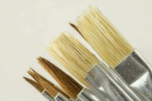 Paintbrushes on light background photo