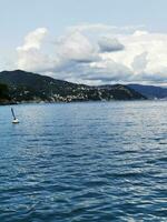 Photo of a boat floating on a peaceful body of water