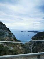 Photo of a serene view of a waterfront from a picturesque bridge