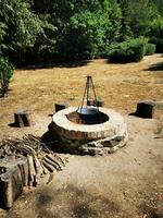 Photo of a blazing fire pit in the middle of a serene field