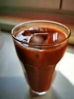 Photo of a refreshing beverage in a glass on a table