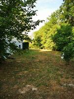 Photo of a picturesque white house surrounded by a lush green landscape