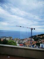 Photo of a crane perched on a high-rise building