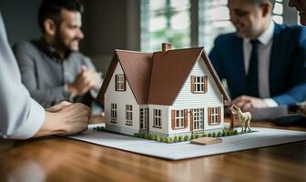 Real estate agent signing a mortgage agreement with a happy young couple with a close-up of a miniature house in the foreground. AI Generated photo