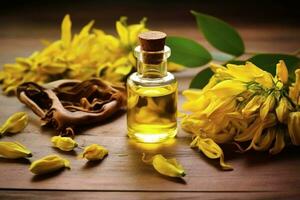 ylang ylang or cananga odorata flower essential oil alongside ylang ylang or cananga odorata flower on a table photo