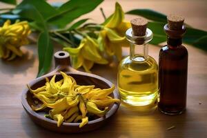 ylang ylang or cananga odorata flower essential oil alongside ylang ylang or cananga odorata flower on a table photo