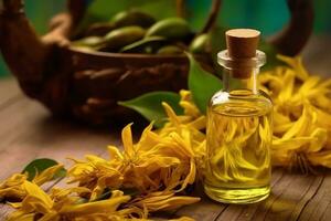 ylang ylang or cananga odorata flower essential oil alongside ylang ylang or cananga odorata flower on a table photo