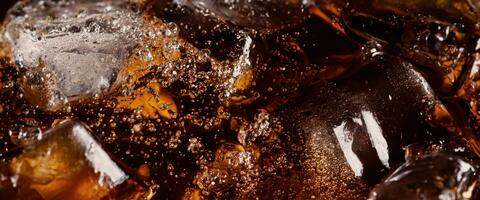 Cola soda and ice splashing fizzing or floating up to top of surface photo