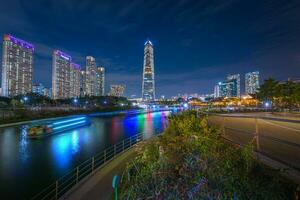 Night view in autumn and beautifully lit tourist boats at Songdo Central Park in Songdo  District, Incheon South Korea. photo