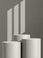 Empty gray podium or pedestal display on gray shadow background with cylinder stand concept photo