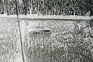 car cleaning and washing with foam soap photo