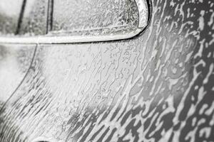 car cleaning and washing with foam soap photo