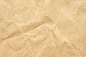 Abstract crumpled and creased recycle brown paper texture background photo