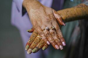 Indian bride showing her mehndi and ring in Indian wedding photo