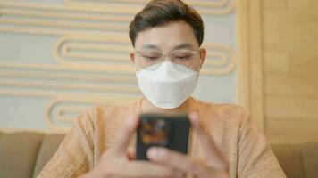 Asians wearing masks chatting on smartphones to protect against coronavirus video