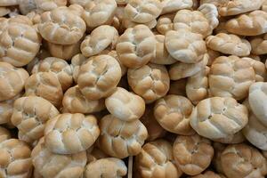 Fresh traditional Czech houska bun with salt and cumin seeds in bakery photo