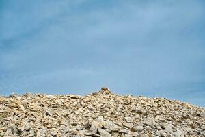 Zen, balanced stones stacked in pyramid on stone run in high mountains against sky, Pirin Mountains photo