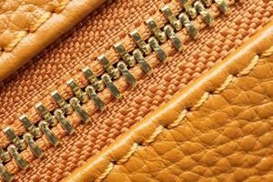 close up of zipper on brown leather bag photo