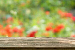 Empty wood table top with blur rose garden background for product display photo