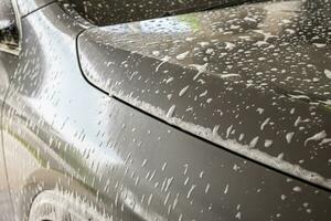 car cleaning and washing with foam soap photo