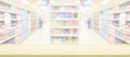 Empty wood table top with supermarket blurred background for product display photo