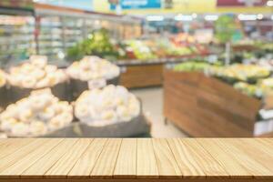 Empty wood table top with supermarket blurred background for product display photo