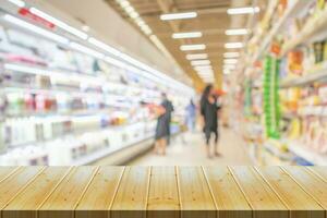 Empty wood table top with supermarket blurred background for product display photo