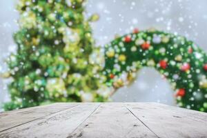 Empty wood table top with blur Christmas tree with bokeh light background photo