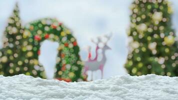 Empty white snow with blur Christmas tree with bokeh light background photo