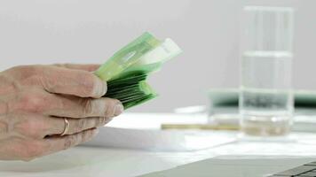 a person is counting money in front of a table video